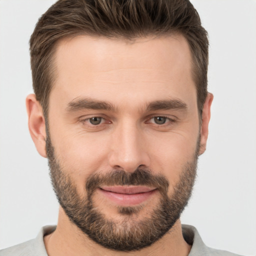 Joyful white young-adult male with short  brown hair and brown eyes