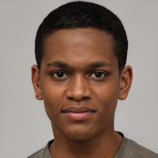 Joyful black young-adult male with short  black hair and brown eyes