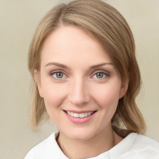 Joyful white young-adult female with medium  brown hair and green eyes