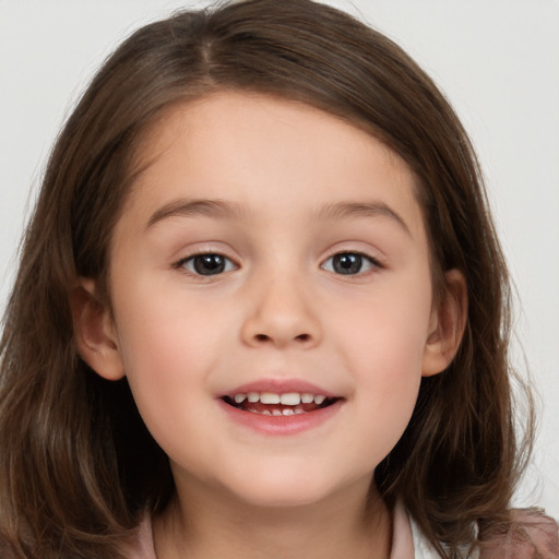 Joyful white child female with medium  brown hair and brown eyes