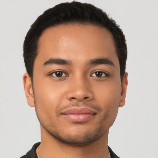 Joyful latino young-adult male with short  brown hair and brown eyes