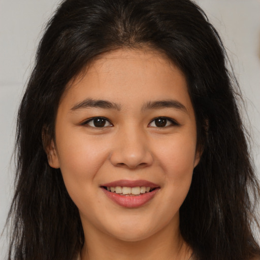Joyful asian young-adult female with long  brown hair and brown eyes