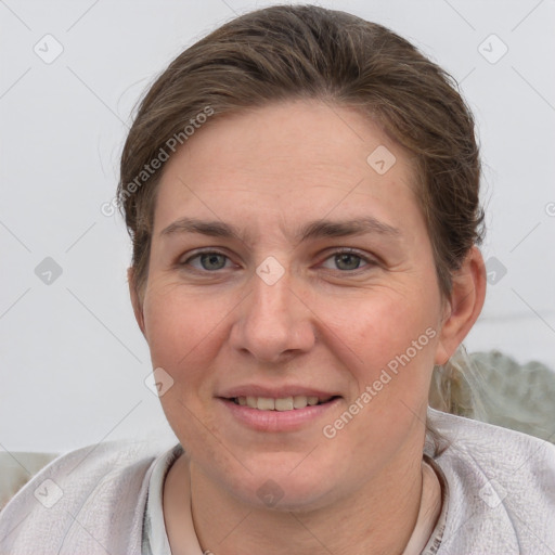 Joyful white young-adult female with short  brown hair and grey eyes