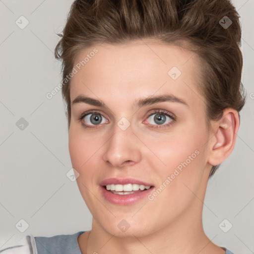 Joyful white young-adult female with short  brown hair and grey eyes