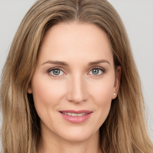 Joyful white young-adult female with long  brown hair and grey eyes