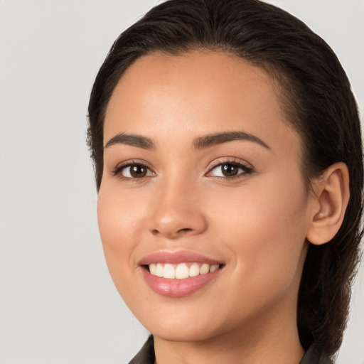 Joyful white young-adult female with long  brown hair and brown eyes