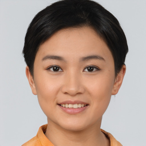 Joyful asian young-adult female with short  brown hair and brown eyes