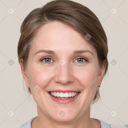 Joyful white adult female with medium  brown hair and blue eyes