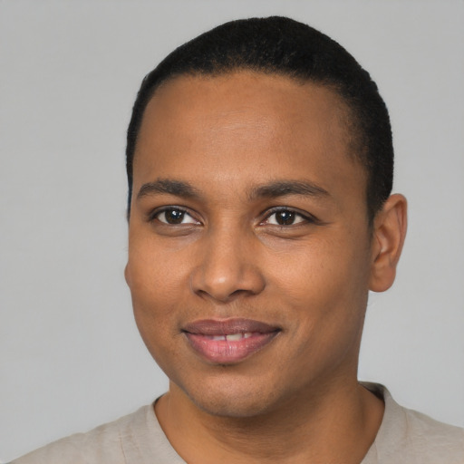 Joyful black young-adult male with short  black hair and brown eyes