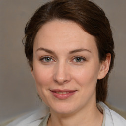 Joyful white adult female with medium  brown hair and brown eyes