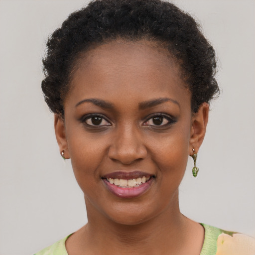 Joyful black young-adult female with short  brown hair and brown eyes
