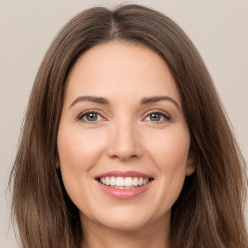 Joyful white young-adult female with long  brown hair and brown eyes