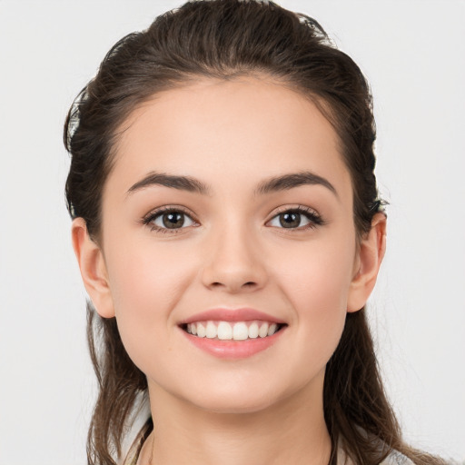 Joyful white young-adult female with long  brown hair and brown eyes