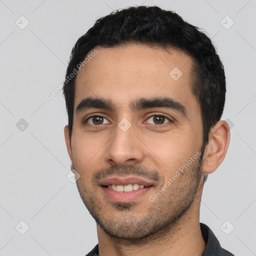 Joyful white young-adult male with short  black hair and brown eyes