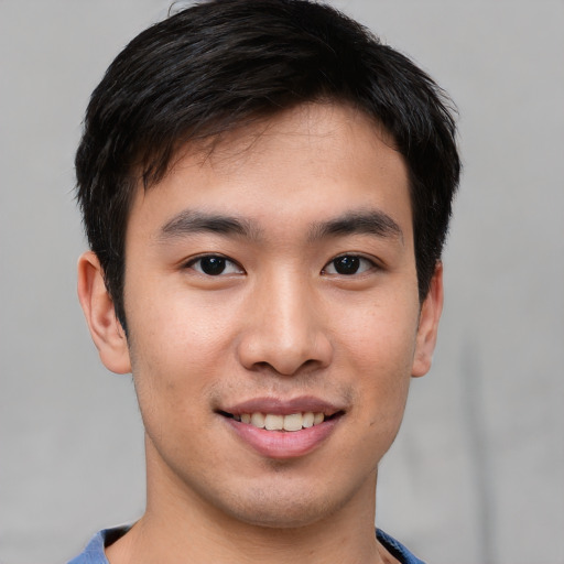 Joyful asian young-adult male with short  brown hair and brown eyes