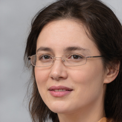 Joyful white adult female with long  brown hair and brown eyes