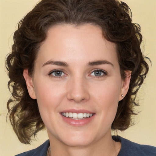 Joyful white young-adult female with medium  brown hair and green eyes