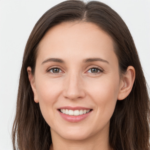 Joyful white young-adult female with long  brown hair and grey eyes