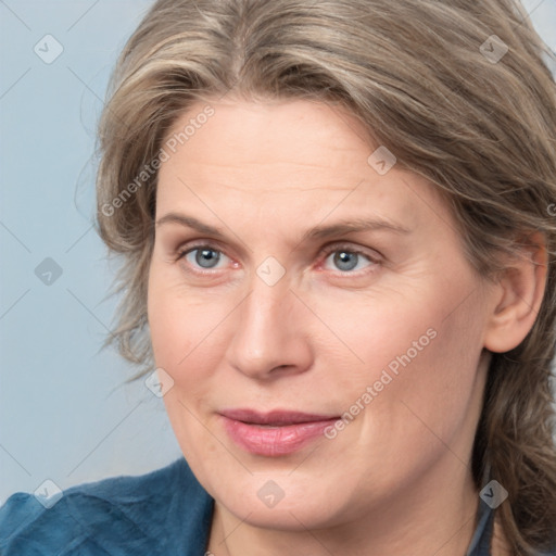 Joyful white adult female with medium  brown hair and blue eyes