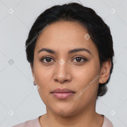 Joyful latino young-adult female with short  black hair and brown eyes