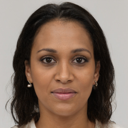Joyful black young-adult female with medium  brown hair and brown eyes