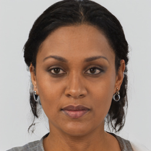 Joyful black adult female with medium  black hair and brown eyes