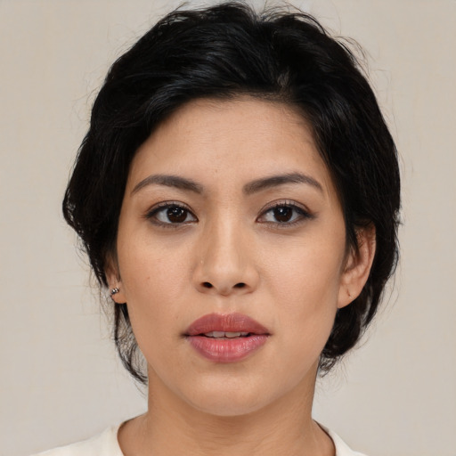 Joyful asian young-adult female with medium  black hair and brown eyes