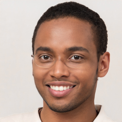 Joyful black young-adult male with short  brown hair and brown eyes