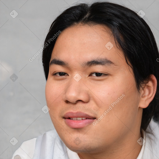 Joyful asian young-adult male with medium  black hair and brown eyes