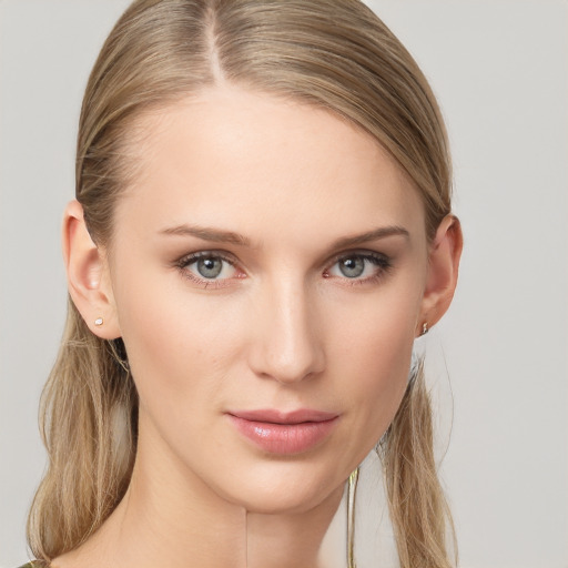 Joyful white young-adult female with long  brown hair and grey eyes