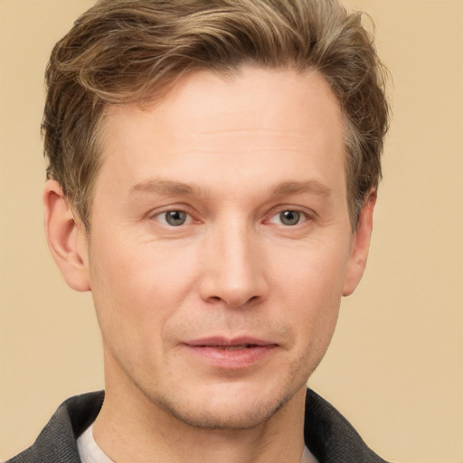 Joyful white adult male with short  brown hair and grey eyes