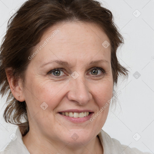 Joyful white adult female with medium  brown hair and grey eyes