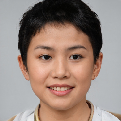 Joyful asian young-adult female with short  brown hair and brown eyes
