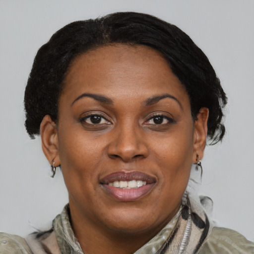 Joyful black young-adult female with medium  brown hair and brown eyes