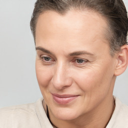 Joyful white adult female with short  brown hair and brown eyes