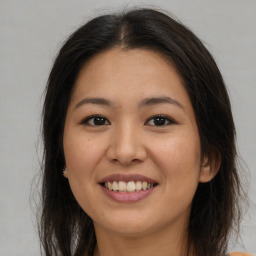 Joyful asian young-adult female with long  brown hair and brown eyes