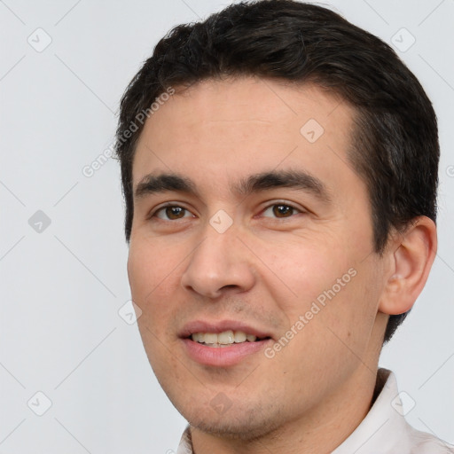 Joyful white young-adult male with short  black hair and brown eyes