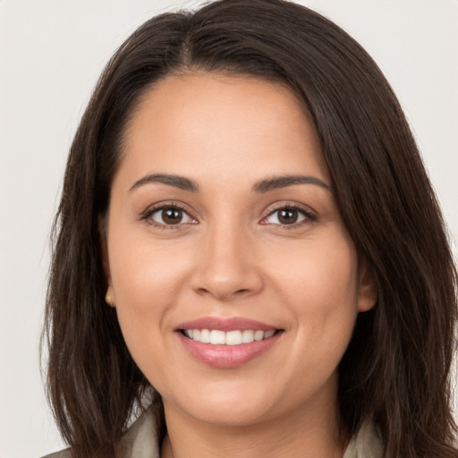 Joyful white young-adult female with long  brown hair and brown eyes