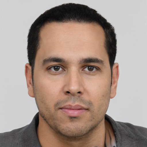 Neutral latino young-adult male with short  black hair and brown eyes