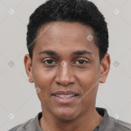 Joyful black young-adult male with short  black hair and brown eyes