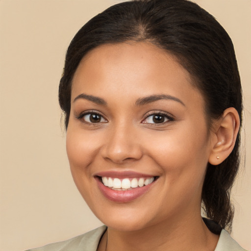 Joyful latino young-adult female with long  brown hair and brown eyes