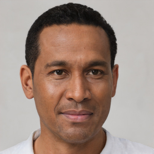 Joyful latino adult male with short  black hair and brown eyes