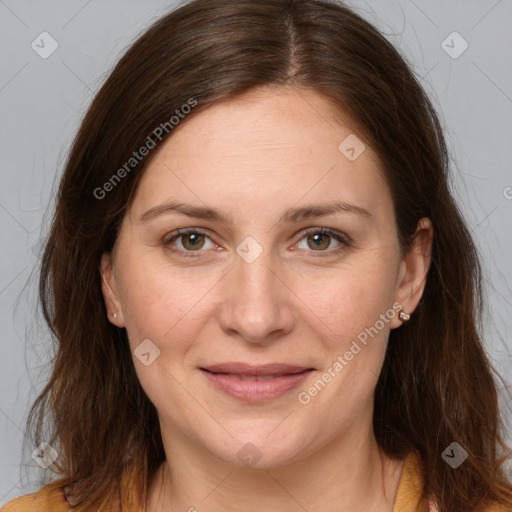 Joyful white adult female with long  brown hair and brown eyes