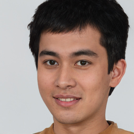 Joyful asian young-adult male with short  brown hair and brown eyes