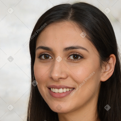 Joyful white young-adult female with long  brown hair and brown eyes