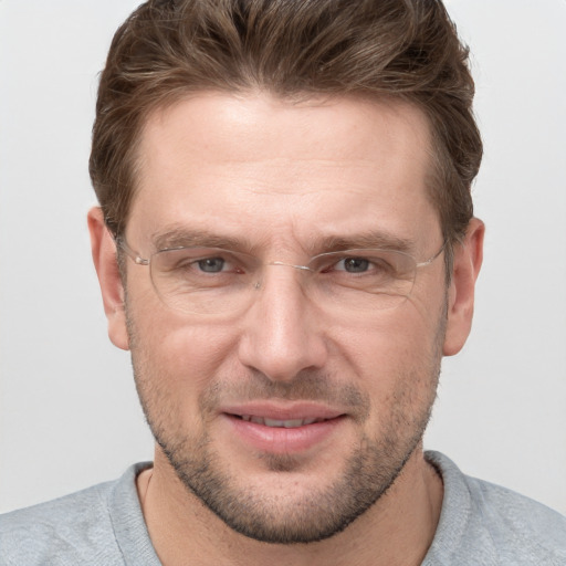 Joyful white adult male with short  brown hair and grey eyes