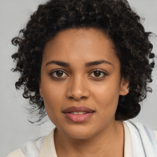 Joyful black young-adult female with medium  brown hair and brown eyes
