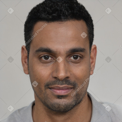 Joyful black young-adult male with short  black hair and brown eyes