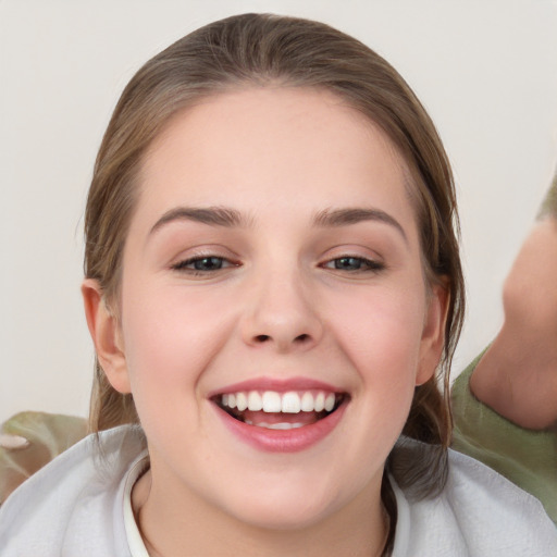 Joyful white young-adult female with medium  brown hair and brown eyes