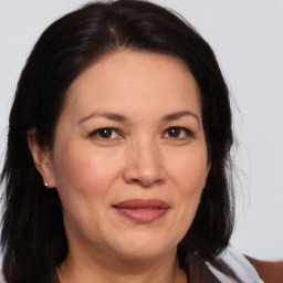 Joyful white adult female with medium  brown hair and brown eyes